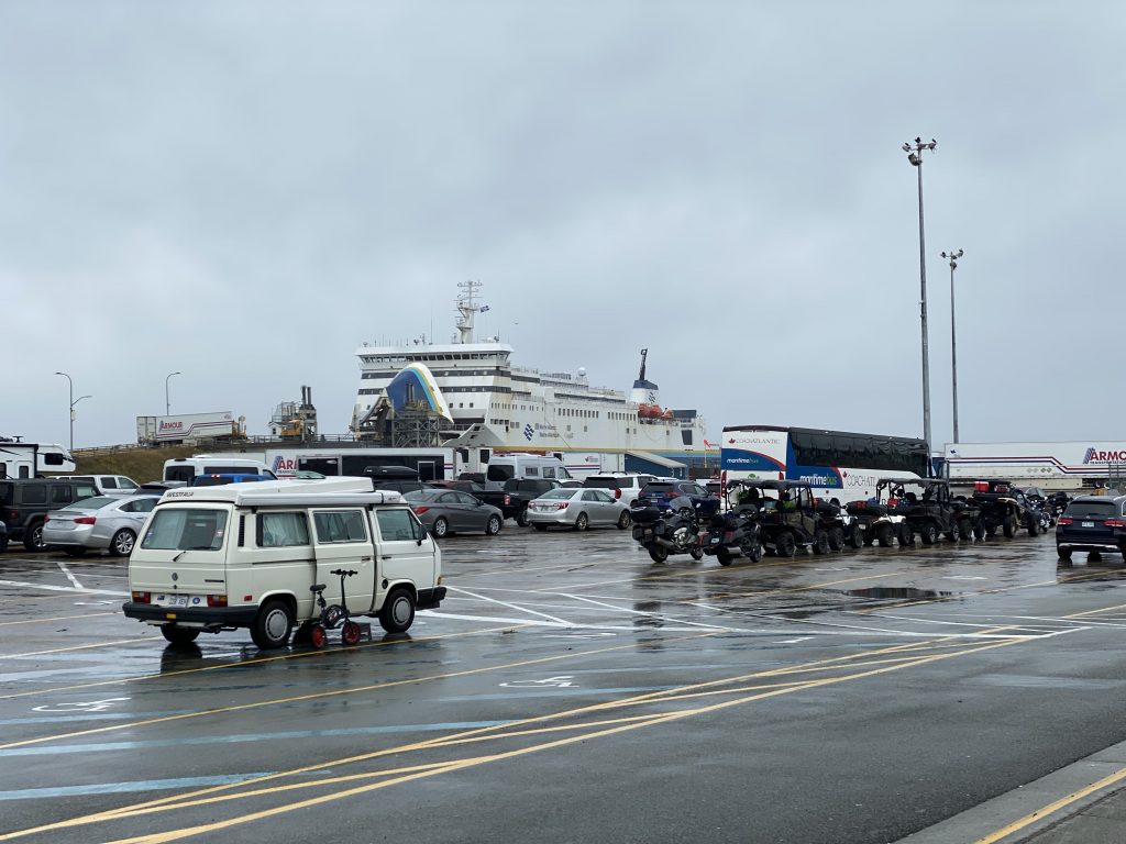 The bikes (just right of center) sit in the wet ferry parking lot, waiting for our boarding call.