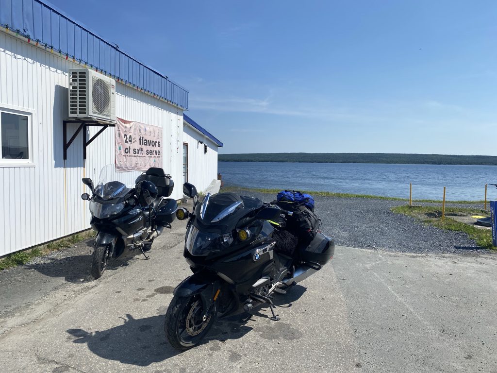 Gander Bay behind the bikes while stopped at a gas station for beverages, in Newfoundland.