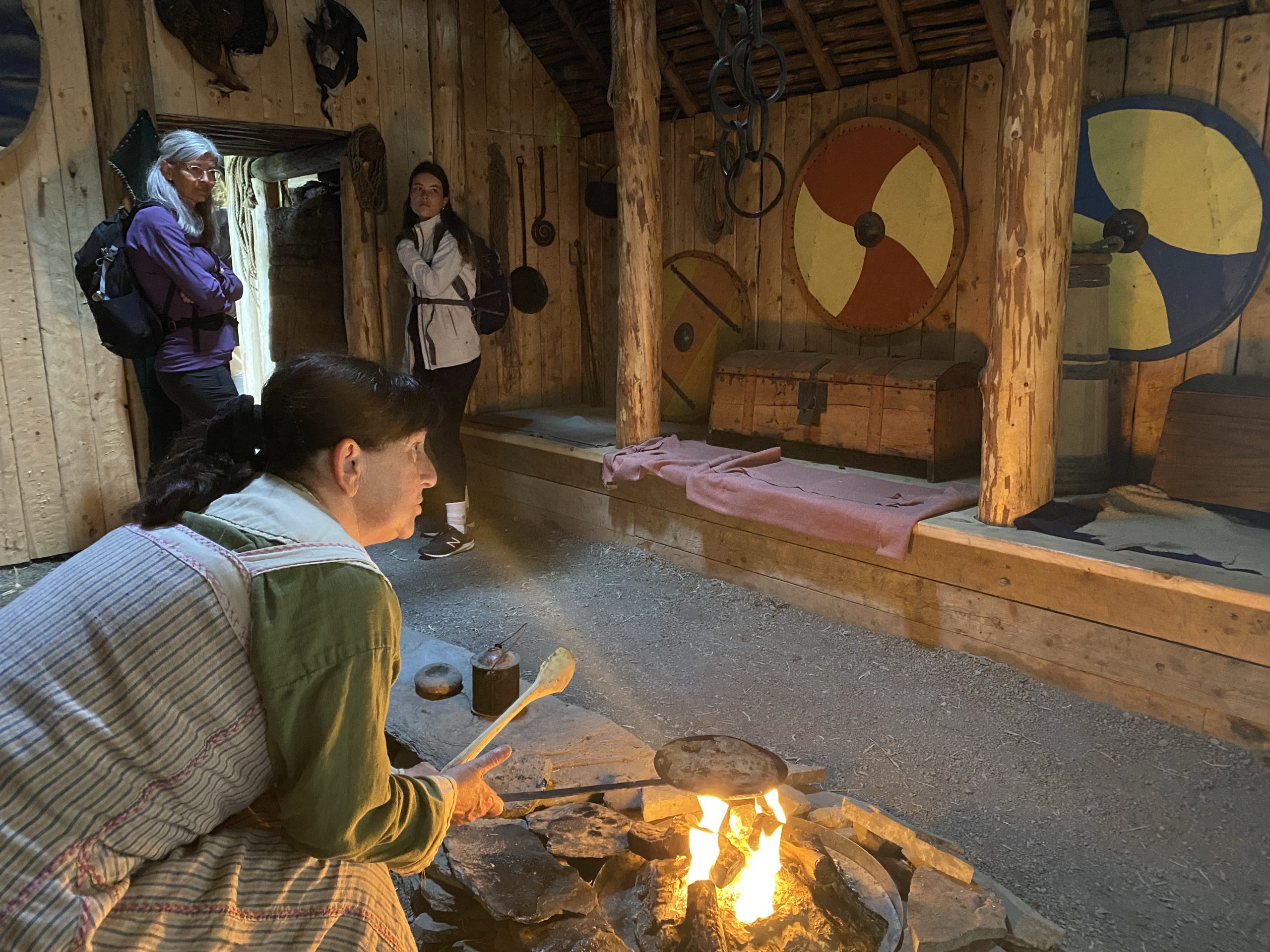 A woman making flatbread in the common room in a recreation of a 1,000 year old Norse sod house. The bread was tasty.