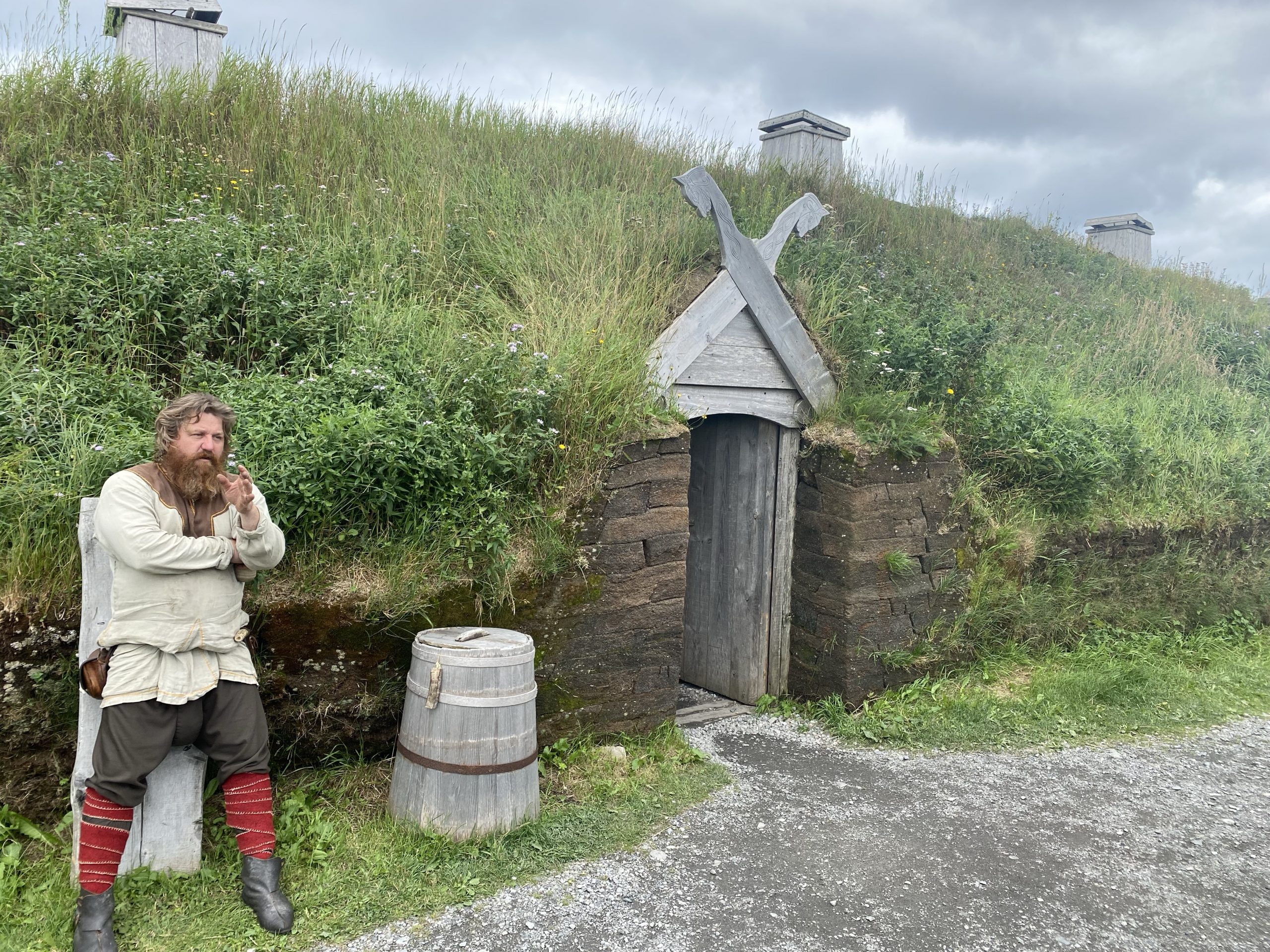 Ragnar (character name) talks to Chuck and I while standing outside an ornate (main) entryway into a re-creation of a 1,000 year old Norse sod house.