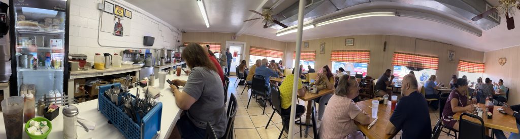 A panoramic view of the bustling activity at the La Escondida Cafe in Roswell, New Mexico.