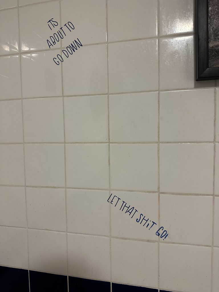 Humorous wall graffiti in a gas station restroom in Seney, Michigan.