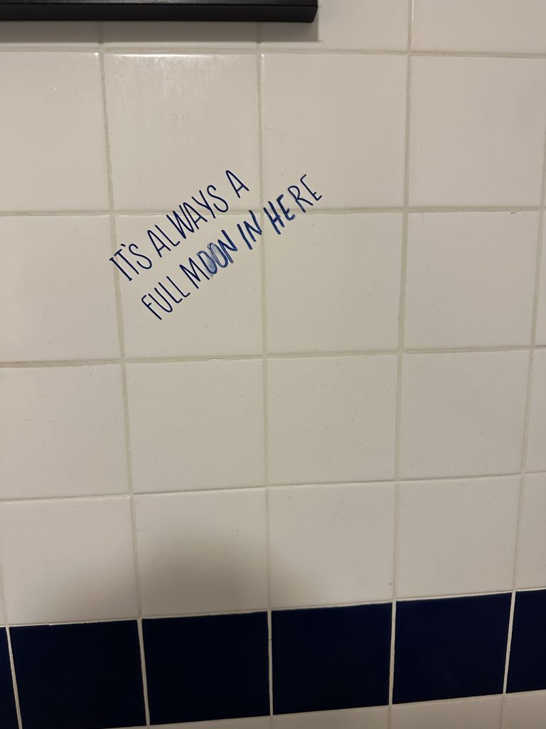 Humorous wall graffiti in a gas station restroom in Seney, Michigan.