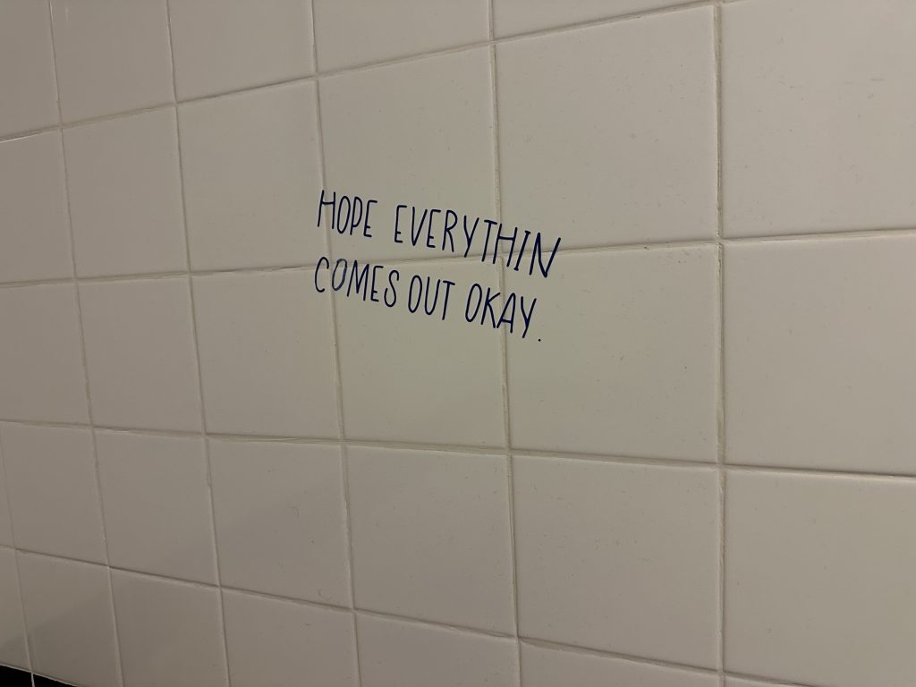 Humorous wall graffiti in a gas station restroom in Seney, Michigan.