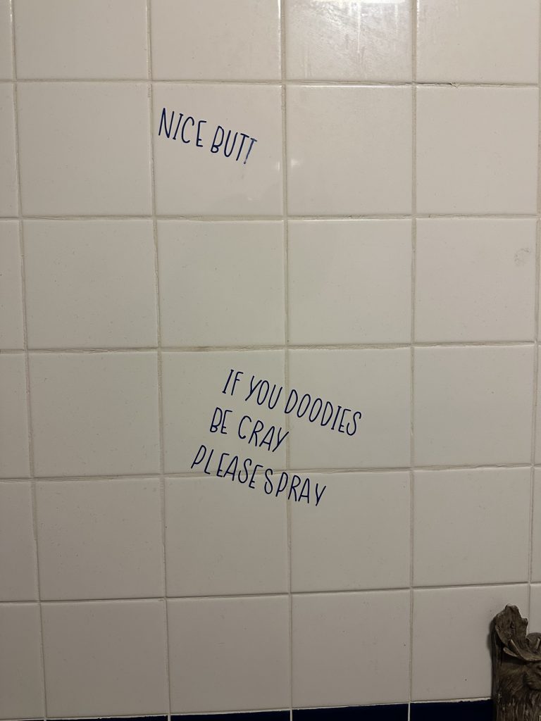 Humorous wall graffiti in a gas station restroom in Seney, Michigan.