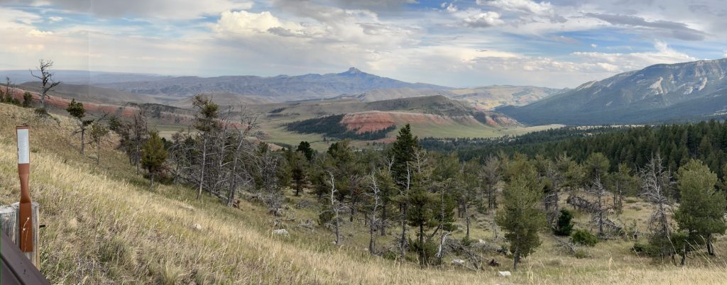 A panoramic view of a red band of geology spanning the entire frame, and well off into the distant background.
